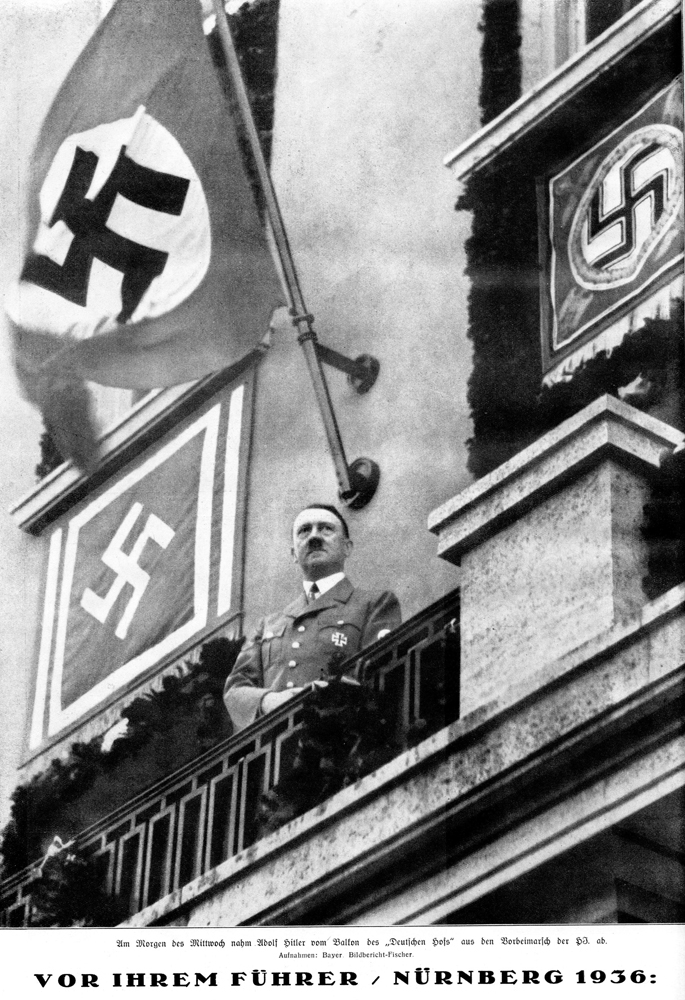 Adolf Hitler reviews the parade of the Hitler Jugend from the balcony of hotel Deutscher Hof in Nuremberg
